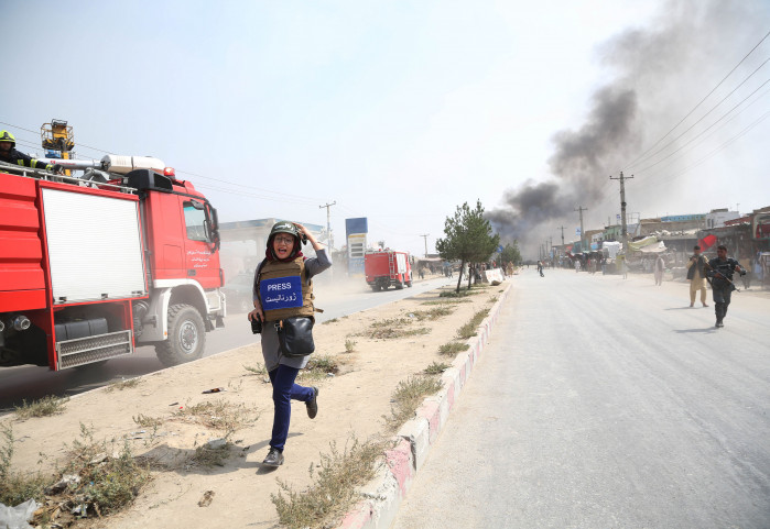 A journalist runs away from the site of a bomb attack in Kabul, capital of Afghanistan, Sept. 3, 2019.