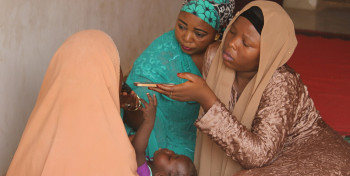 Two women interview an internally displaced person in Nigeria's Borno State